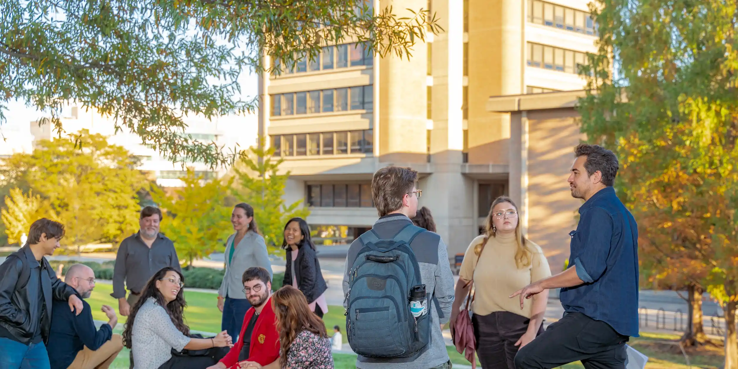 A banner image showing an English Department faculty members talking to English students