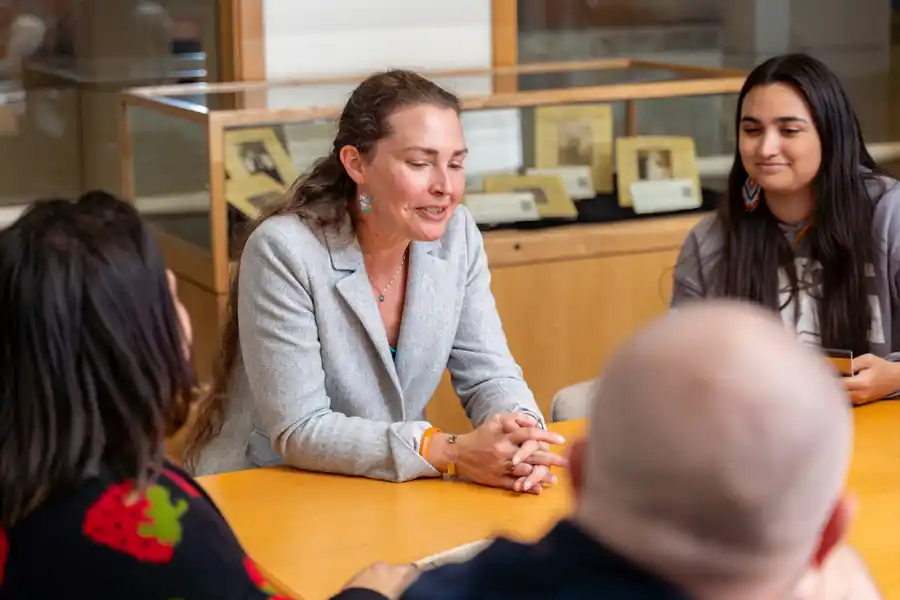 A photograph of a Rhetoric, Writing, and Linguistics professor with students